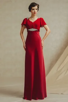 Robe rouge de soirée Empire coupe fluide soulignée d'un boucle en strass